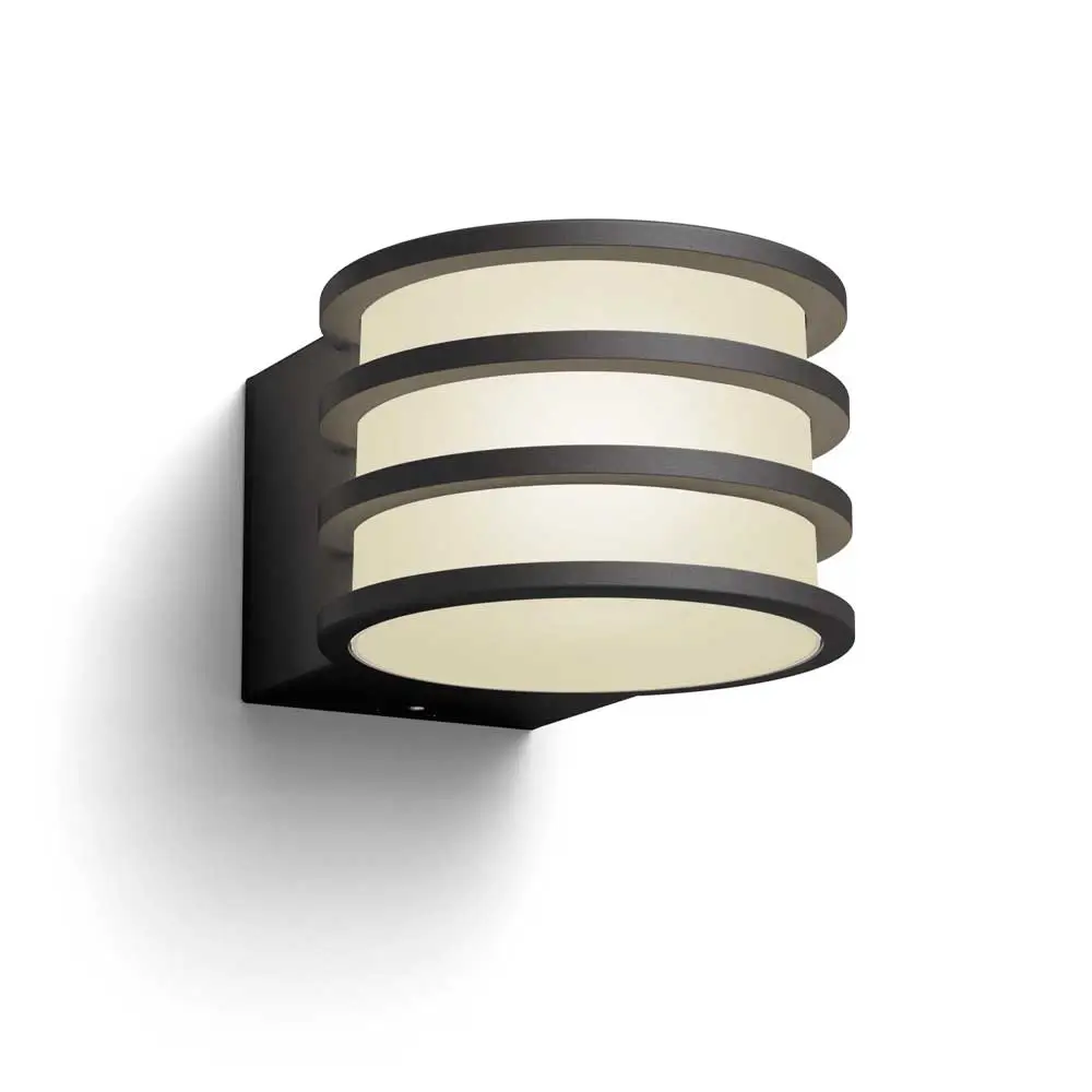 Aplique exterior Lucca Philips Hue negro antracita encendido con luz blanca cálida.