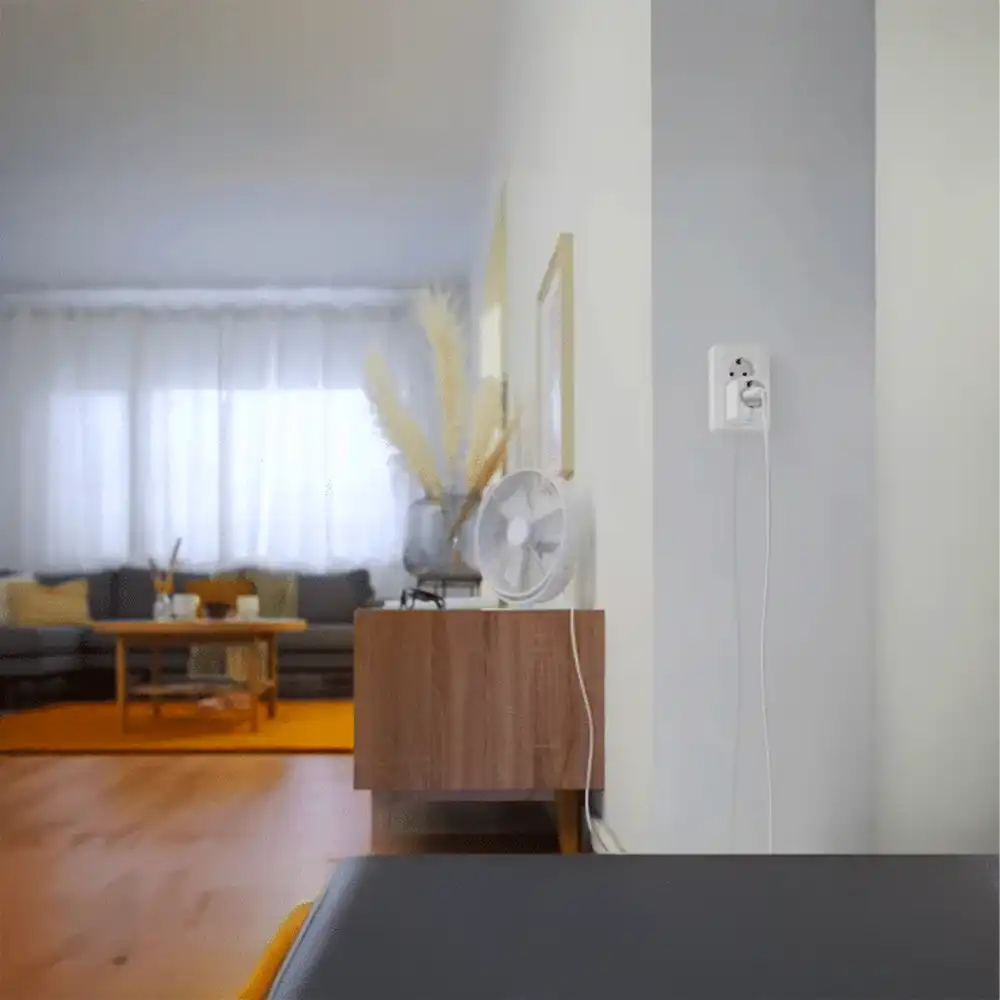 Enchufe inteligente WiZ blanco conectado en pared de salón.