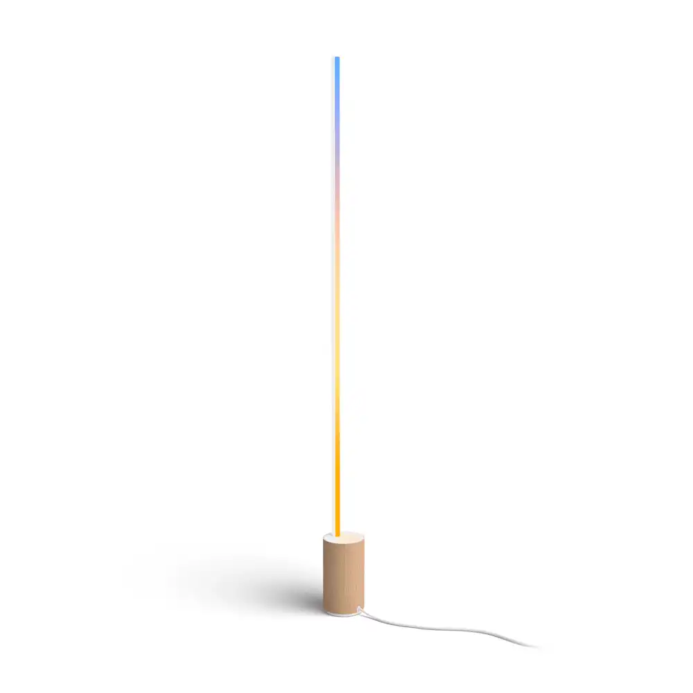 Lámpara de suelo Gradient Signe Philips Hue blanca y madera encendida con degradado multicolor vertical
